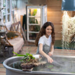 gardener-woman-touches-with-hand-the-water-in-bath-2025-03-09-06-38-17-utc-DVKUNZL